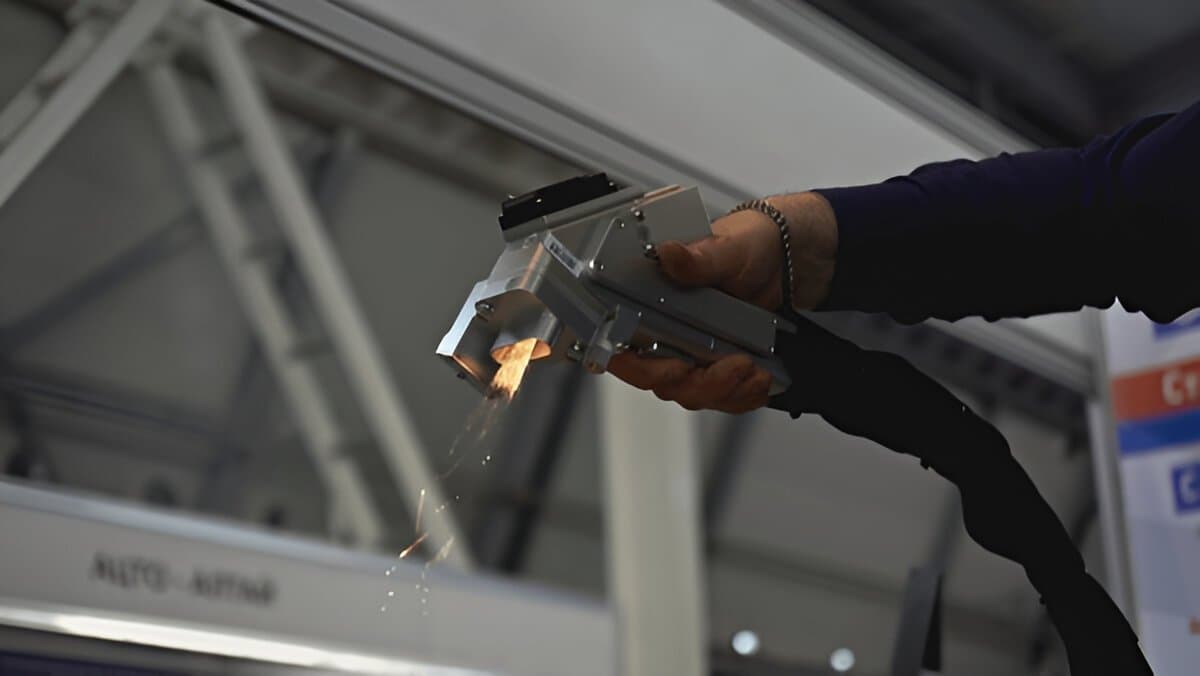 Handheld laser cleaning head in action